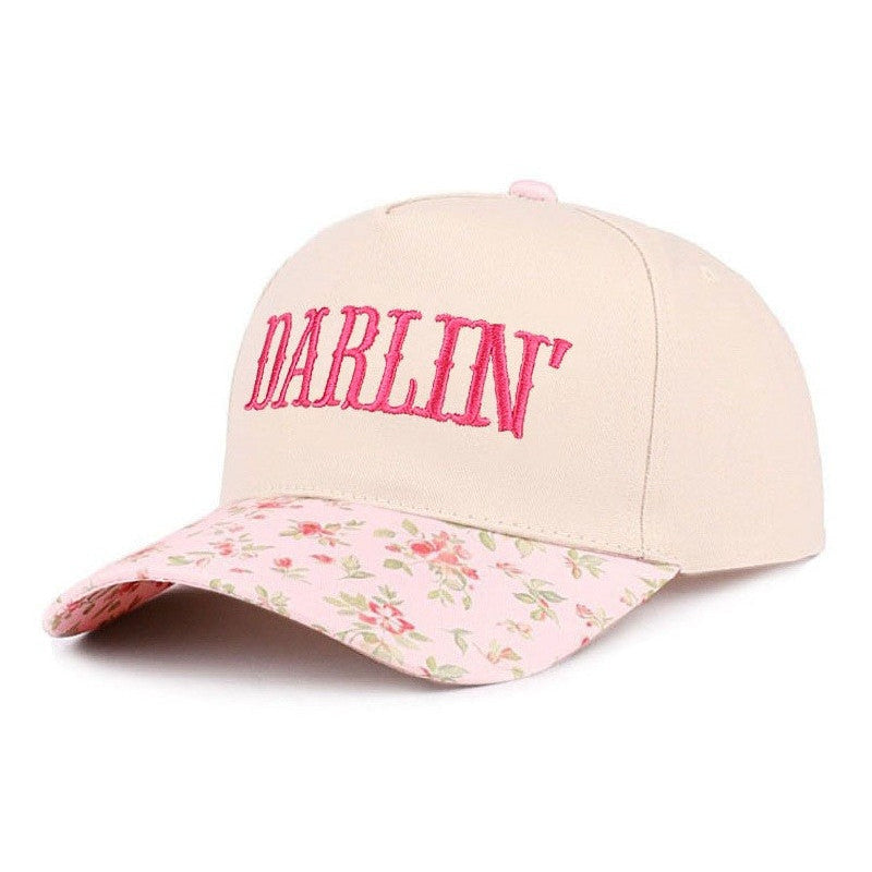 Beige cap with floral brim and 'Darlin' text in pink on a white background