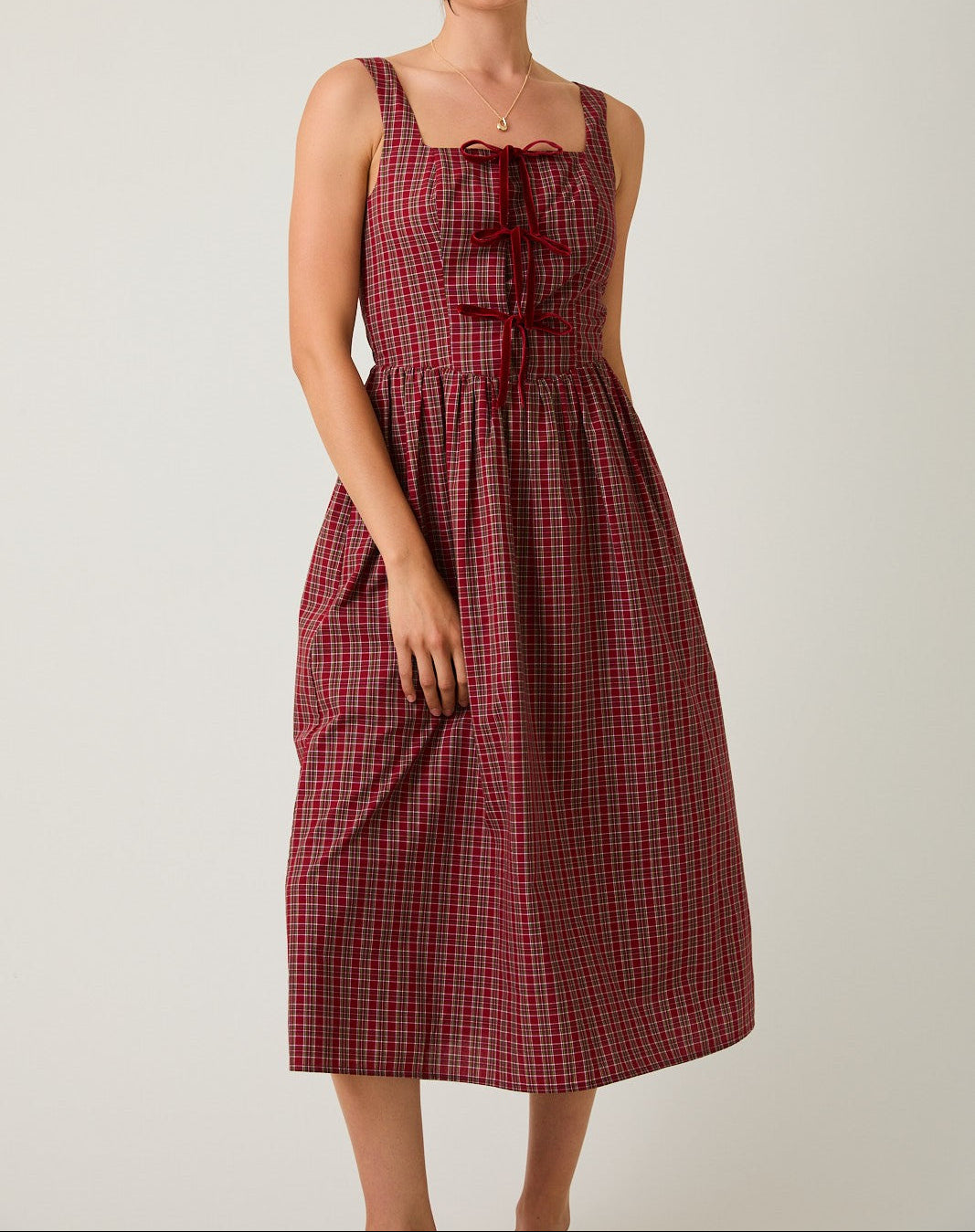 Woman wearing a red checkered dress 